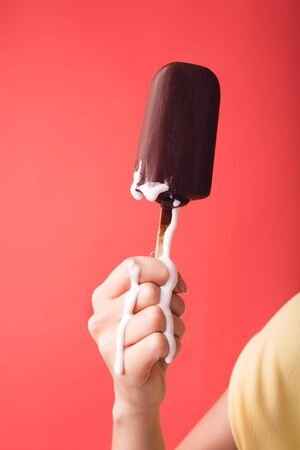 Hand holds chocolate vanilla ice cream.の写真素材