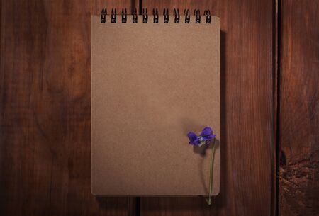 Old notepad on the wood background