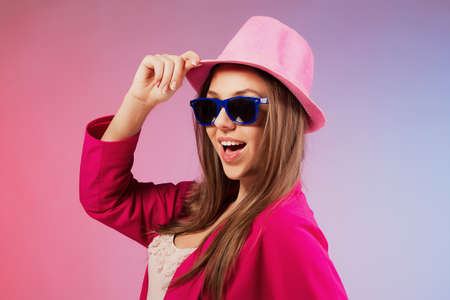 Portrait of a cheerful young girl in bright casual clothes smiling at the camera with beautiful smile.の写真素材