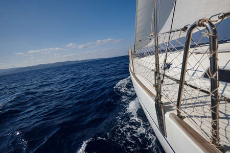 The white sails of yachts on the background of sea and skyの写真素材