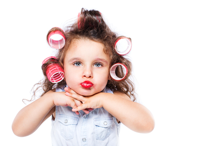 Adorable funny little girl making makeup with mother cosmeticsの写真素材