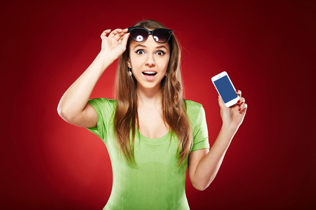 beautiful emotional woman over red backgroundの写真素材