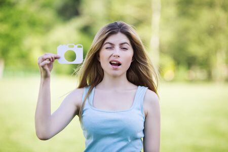 Young girl with a cardboard symbol of cameraの写真素材