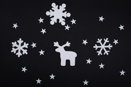 Merry Christmas card with snowflake decorations in paper cutting style over black.の写真素材