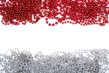 Lines of red and silev beads garland thread isolated on white background.の写真素材