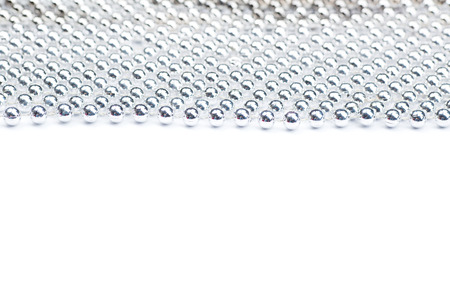 Lines of silver beads garland thread isolated on white background.の写真素材