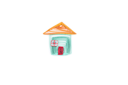 Small house made in quilling technique on white background.の写真素材