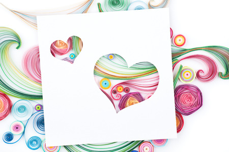 Concept of hearts on colorful paper made with quilling technique on white backgroundの写真素材