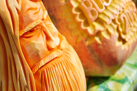 Decorated pumpkins with knife on sunshine.の写真素材