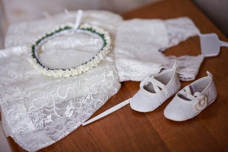 Wedding dress for child on wooden table.の写真素材