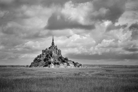 Mont Saint-Michel on sunny day with clouds in b / wの写真素材
