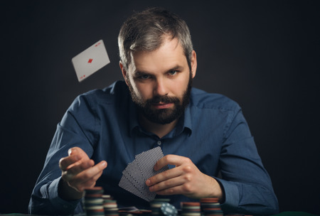 Men with poker cards on balck background..