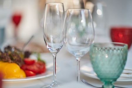 glasses and a plate with vegetables on the tableの写真素材