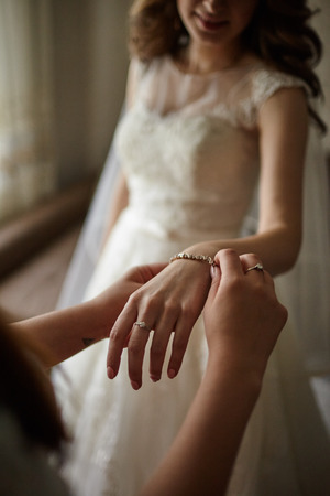 The bride is wearing a bracelet on her armの写真素材