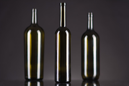 Dark green bottles on a black backgroundの写真素材