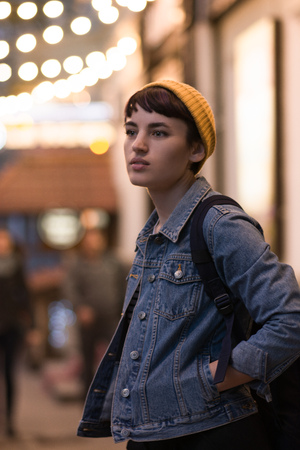 beautiful brunette with short haircut on a background of a night cityの写真素材