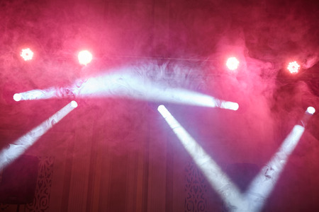 red light, smoke, floodlight on a dark backgroundの写真素材