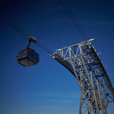 funicular on the background of snowy mountains and blue skyの写真素材