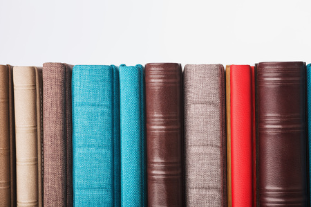 multi-colored albums of different sizes and textures on a white background