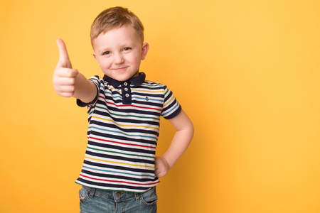 little boy in the studio on a yellow background