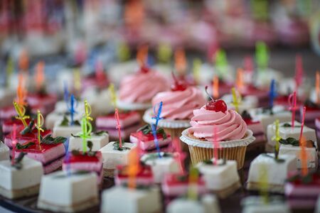 the wedding table is decorated with many beautiful dessertsの写真素材