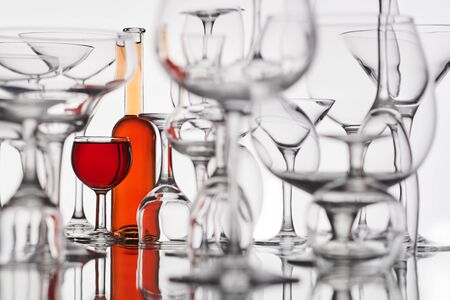 different glasses with a red drink on a white backgroundの写真素材
