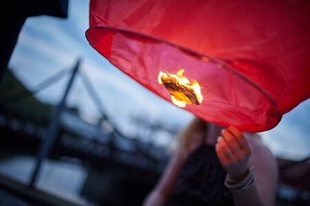 fiery balloon launched into the sky above the cityの写真素材