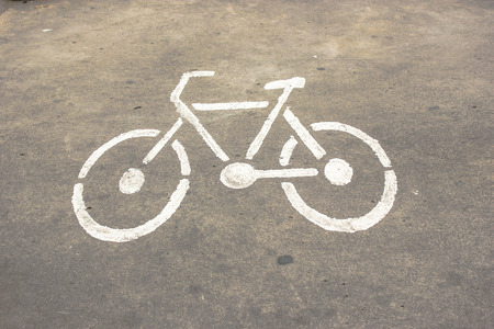 white signs bicycle on cement roadの写真素材