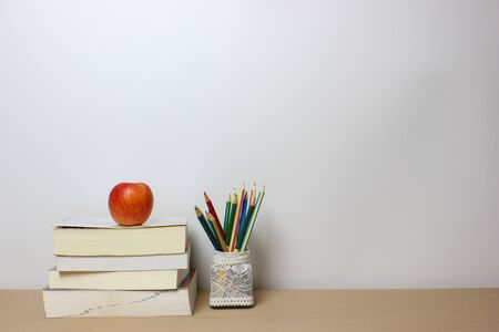 Back to school concept. Book clock and pencil on isolated white background. Copy space.の写真素材