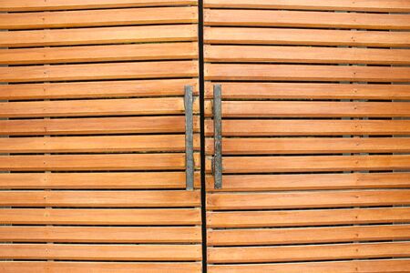 Part of brown wood doors and black metal handle. Wood doors modern styleの写真素材