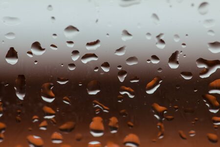 rain drops on the window with blurred backgroundの写真素材
