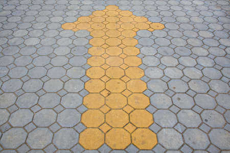 Arrow sign on brick way