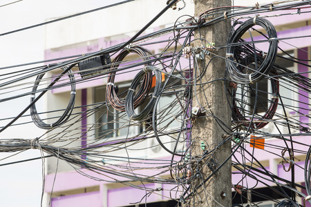 The chaos of cables and wires in Thailandの写真素材