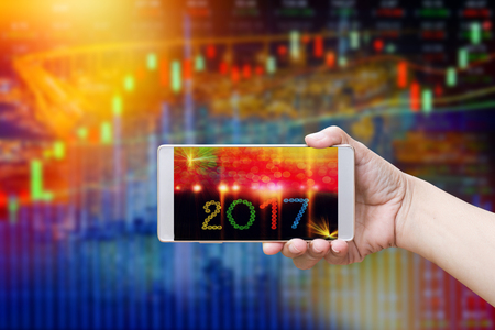 Men hand holding smartphone The screen is number 2017