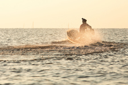 Back view of man on boat over the lake