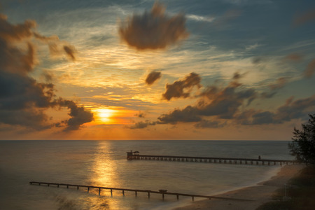 Tropical beach with sunrise over the seaの写真素材