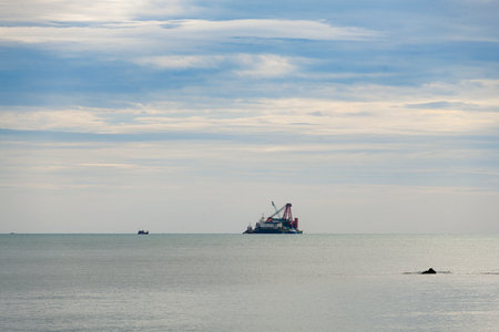 Seascape with cargo ship and blue sky in the evening.の写真素材