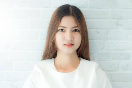 Portrait of a beautiful business woman modern on wall backgroundの写真素材