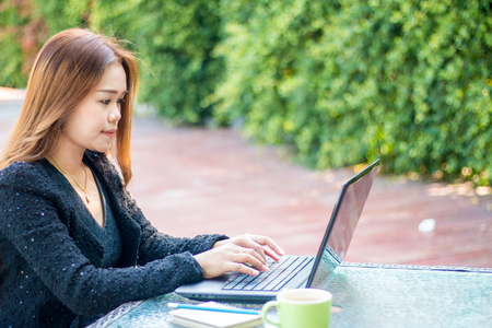 Modern business woman uses a laptop to work in morningの写真素材