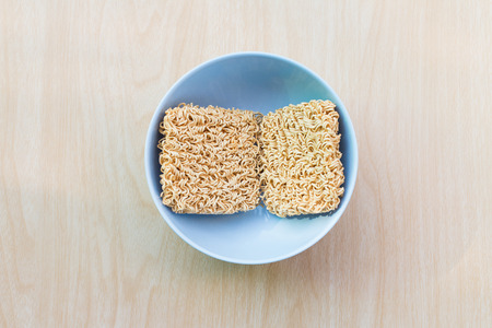Top view Before hot water bowl of instant noodles on wooden tableの写真素材