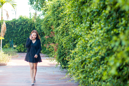 Young woman with modern business To walk the phone, communicate.の写真素材