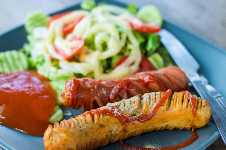 Sausage steak in a dish on wooden floor