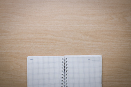 Top view Notebook on the desk is a wooden surface with copy spaceの写真素材