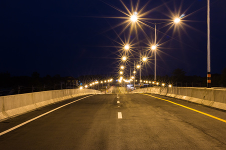 Paved roads and traffic lines Refreshing new at nightの写真素材