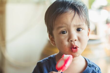 Kids eat ice cream happily and fun.の写真素材