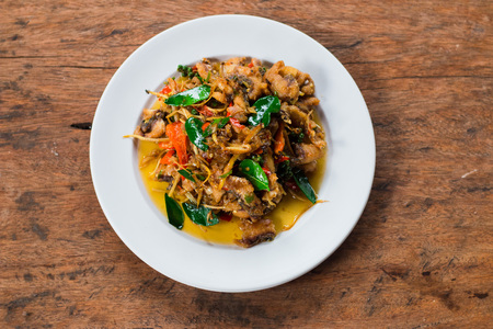 Top view, Stir fried spicy fish on a wooden floor.の写真素材