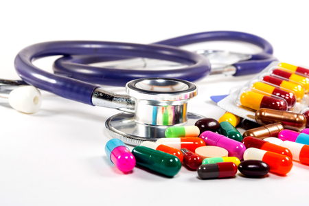 Medical concept  Doctors Stethoscope With  Colorful  Pills on white backgroundの写真素材