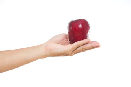 Men hand holding the red apple on white isolate background.の写真素材
