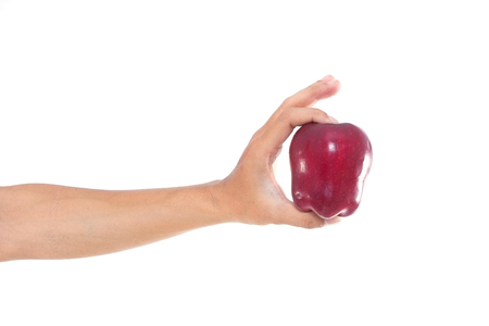 Men hand holding the red apple on white isolate background.の写真素材