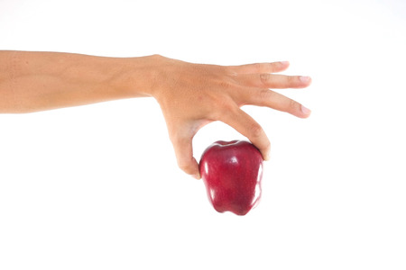 Men hand holding the red apple on white isolate background.の写真素材